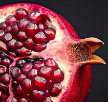 AI generated close up half pomegranate isolated on black background photo