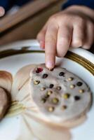 Child having fun modeling salt dough, authentic activity, fine motor skills development photo