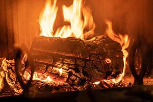 Log of wood burning in a fireplace inside a house, hearth photo