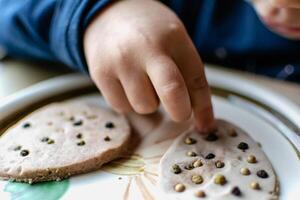 Child having fun modeling salt dough, authentic activity, fine motor skills development photo