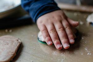 Child having fun modeling salt dough, authentic activity, fine motor skills development photo