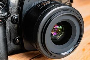 Reflex camera or dslr with reflexion on lens, photograph equipment, for professionnal and agency photo