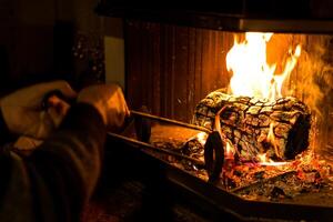 Log of wood burning in a fireplace inside a house, hearth photo