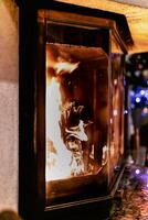 Log of wood burning in a fireplace inside a house, hearth photo