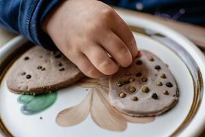 Child having fun modeling salt dough, authentic activity, fine motor skills development photo