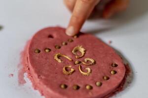 Child having fun modeling salt dough, authentic activity with natural pink coloring beet juice, fine motor skills development photo