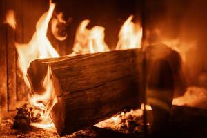 Log of wood burning in a fireplace inside a house, hearth photo