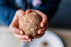 Child having fun modeling salt dough, authentic activity, fine motor skills development photo