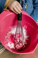 Child having fun modeling salt dough, authentic activity with natural pink coloring beet juice, fine motor skills development photo