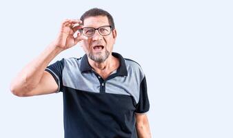 Amazed senior man taking off glasses isolated. Surprised senior man taking off glasses looking at camera photo