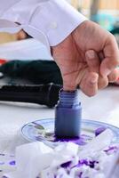 Voter Dipping His Pinkie into Ink Bottle to Proof Already Cast the Ballot photo