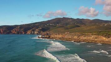 Drone view rocky ocean coastline and waves with white foam video