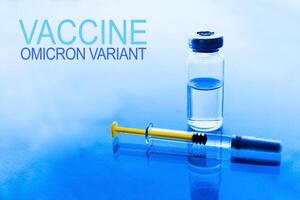 Vials of medication and syringe on a blue glass table with window background photo