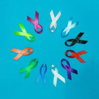 World cancer day February 4 background. Colorful ribbons, cancer awareness. blue surface from above photo