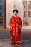 mujer vestir China nuevo año. retrato de un mujer. persona en tradicional traje. mujer en tradicional traje. hermosa joven mujer en un brillante rojo vestir y un corona de chino reina posando foto