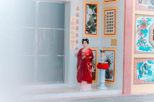 Woman dress China New year. portrait of a woman. person in traditional costume. woman in traditional costume. Beautiful young woman in a bright red dress and a crown of Chinese Queen posing. photo