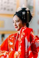 mujer vestir China nuevo año. retrato de un mujer. persona en tradicional traje. mujer en tradicional traje. hermosa joven mujer en un brillante rojo vestir y un corona de chino reina posando foto