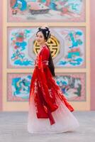 Woman dress China New year. portrait of a woman. person in traditional costume. woman in traditional costume. Beautiful young woman in a bright red dress and a crown of Chinese Queen posing. photo