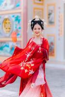 mujer vestir China nuevo año. retrato de un mujer. persona en tradicional traje. mujer en tradicional traje. hermosa joven mujer en un brillante rojo vestir y un corona de chino reina posando foto