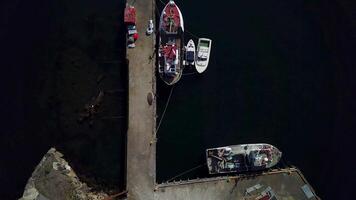 Pier with the ships in the port city. Lofoten archipelago in Norway. Top view video