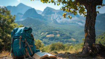 AI generated hiking backpack and book under a tree with mountains in background photo