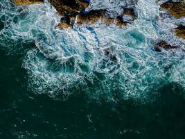 sea waves hitting the stones photo