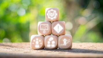 Team building concept, Wooden block on desk with team building icon on virtual screen. Team Spirit, Motivation, Training, Competency, Collaboration, Communication, Goal, Social Relations. photo