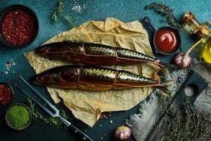 Smoked mackerel on a cutting board on a stone background photo