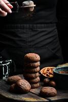 Chocolate brownie cookies with peanut butter filling. Macro photo. On a black background. photo