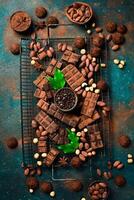 Chocolate background. Banner of chocolate, cocoa, nuts and cocoa beans. Top view, space for text. photo