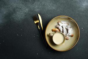 Baking. Mini croissants with jam and powdered sugar. On a black stone background. Free space for text. photo