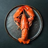 Big red boiled lobster. Close-up on slate surface. Seafood, top view. photo