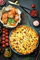 Georgian khachapuri with cheese. Pizza with cheese. On a black stone background. In a plate, close-up. photo