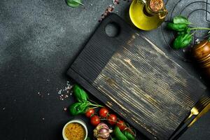 Cooking table with herbs, spices and utensils. Top view with copy space photo