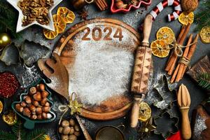 Christmas baking background. Kitchen cutting board and baking ingredients. Christmas and New Year food. Top view of kitchen table. photo