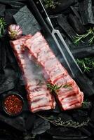 Meat. Raw Pork ribs with rosemary. Top view. Rustic style. photo