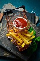 French fries and ketchup sauce. Advertising photo. Free space for text. On a dark background. photo