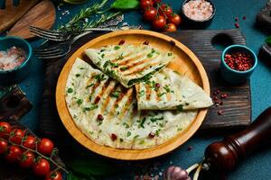 Traditional azerbaijan cuisine flat bread with herbs and meat. Kutaby qutab kutab. Free space for text. On a dark background. photo