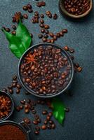 Roasted Arabica or Robusta coffee beans in a black bowl. Macro photo. Coffee background. photo