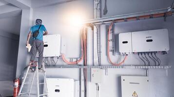 A technician is carrying out maintenance on a solar power inverter panel, the concept of regular maintenance on an inverter. photo