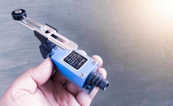 The technician hold the limit switch component electrical automation switching. photo