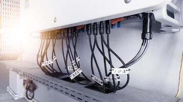 Cable connecting the power from the solar panel to the inverter with shiny light. Cable string connection on inverter control solar panel. Socket input supply voltage and Technology of solar energy. photo