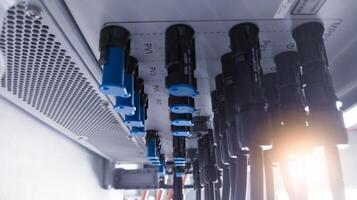 Cable connecting the power from the solar panel to the inverter with shiny light. Cable string connection on inverter control solar panel. Socket input supply voltage and Technology of solar energy. photo