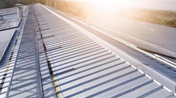 Photovoltaic solar panels mounted on building roof for producing clean ecological electricity at sunset.Photovoltaic panels on the roof.View of solar panels in the building,renewable energy concept photo