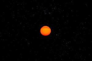 Orange sun in the dark sky. photo