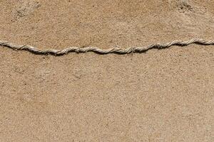 Old rope on the sand. photo