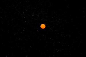 Orange sun in the dark sky. photo