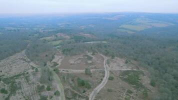 Aerial view of a lush countryside with winding trails and patches of forest. video