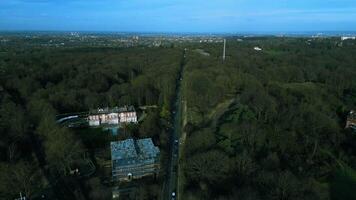 Beautiful aerial video of the cars driving on the road between parks in London