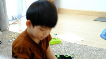 Asian boy playing with plasticine in the room video